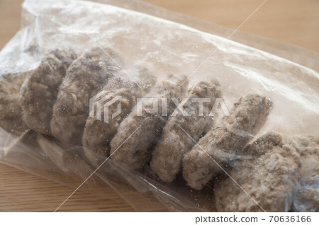 Lots of frozen hamburgers in plastic bags Lots of frozen hamburgers in plastic bags 70636166