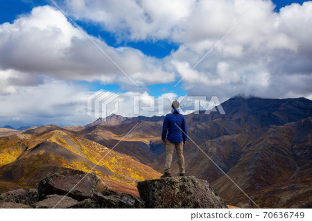 Man Standing and Looking at Viewpoint of Mountain Range 70636749