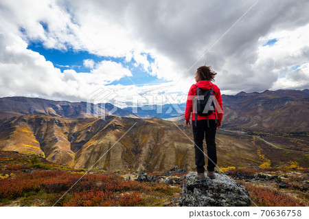 Woman Standing and Looking at Mountain Range 70636758