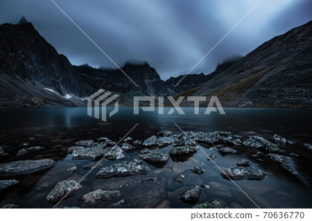 Beautiful Dramatic View of Rugged Mountains and Alpine Lake at Twilight 70636770