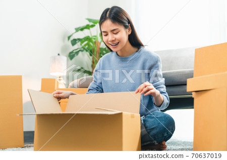 Young Asian woman pack the product and send to the customer. 70637019