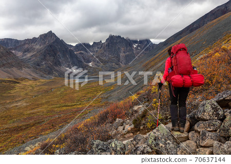Woman Backpacking on Scenic Rocky Hiking Trail to Lake 70637144