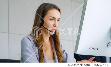 Business people wearing headset working in office Business people wearing headset working in office 70637567