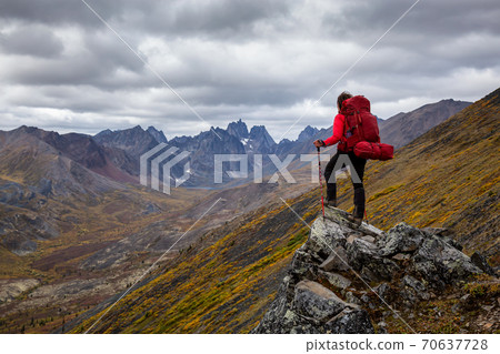 Woman Backpacking on Scenic Rocky Hiking Trail 70637728
