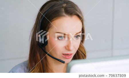 Business people wearing headset working in office Business people wearing headset working in office 70637809
