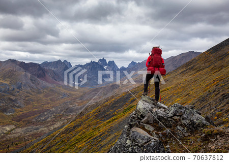 Woman Backpacking on Scenic Rocky Hiking Trail 70637812