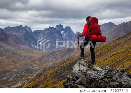 Adventurous Woman surrounded by Mountains in Fall 70637843