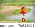 red ceramic bells hanging on a string 70638001