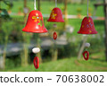 red ceramic bells hanging on a string 70638002