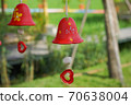 red ceramic bells hanging on a string 70638004