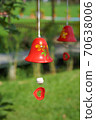 red ceramic bells hanging on a string 70638006