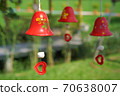 red ceramic bells hanging on a string 70638007