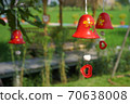 red ceramic bells hanging on a string 70638008