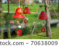 red ceramic bells hanging on a string 70638009