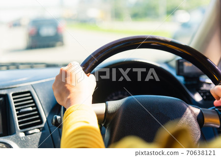 woman while driving the car woman while driving the car 70638121