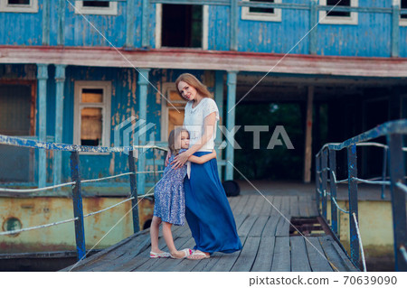 mom and kids in blue clothes standing old bridge mom and kids in blue clothes standing old bridge 70639090