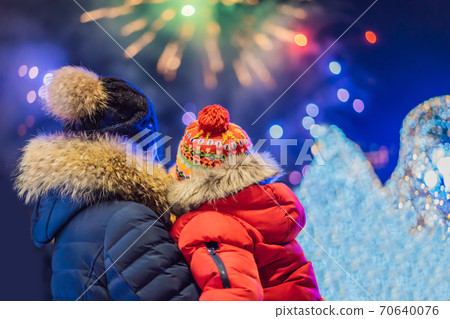 happy family looking fireworks in the evening sky. fireworks new year, christmas. Crazy 2020 is over, it's 2021 happy family looking fireworks in the evening sky. fireworks new year, christmas. Crazy 2020 is over, it's 2021 70640076