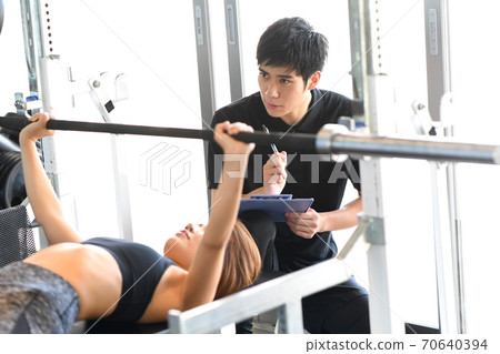 Female and male trainers on the bench press 70640394