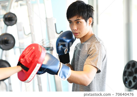 Young man hitting a mitt in the gym 70640476