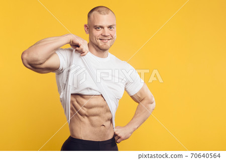 Closeup portrait of muscular man in white shirt Closeup portrait of muscular man in white shirt 70640564