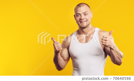Closeup portrait of muscular man in white shirt 70640598