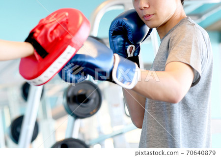 Young man hitting a mitt in the gym 70640879