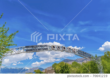 Welcome arch at the city of Ogden Utah against vivid blue sky and puffy clouds 70641219