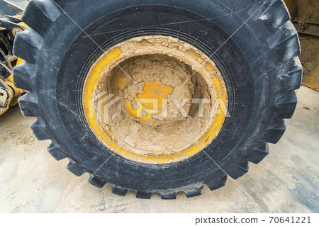 Close up view of the heavy duty black rubber tire of a construction vehicle 70641221