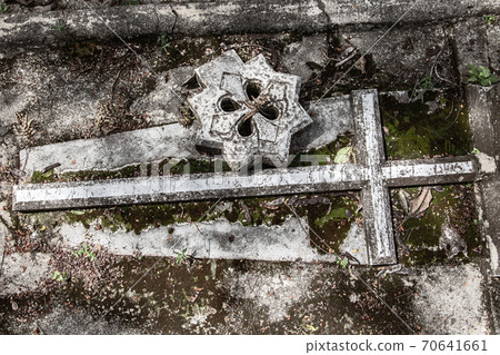 The ancient mysterious grave with cross at cemetery. The ancient mysterious grave with cross at cemetery. 70641661