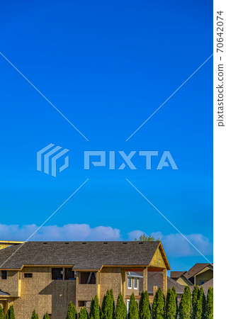 Exterior of a house under construction with blue sky background on a sunny day 70642074