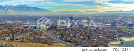 Utah State Capital Building and skyscrapers towering over the populous city 70642374