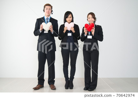 Three young female and male operators in suits with hearts (whole body) 70642974