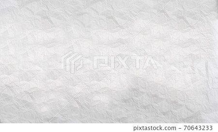 Heavily crumpled sheet of white paper with a textured surface .Texture or background 70643233