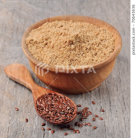 porridge of flax seed on wooden board 70643636