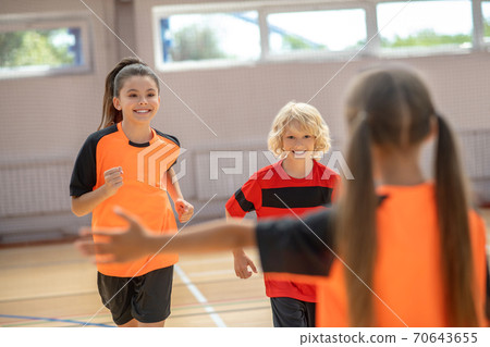 Kids in bright sportswear feeling excited in gym 70643655