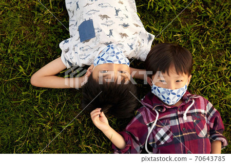 Boy lying on the grass 70643785