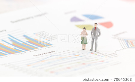 Miniature figures businessman standing on a graph chart Miniature figures businessman standing on a graph chart 70645368