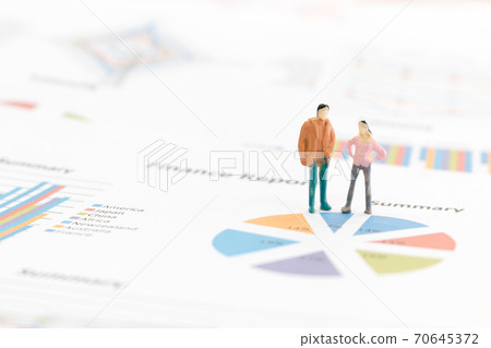 Miniature figures businessman standing on a graph chart 70645372