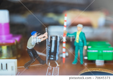 Miniature people : Worker team repairing Electronic Circuits. Miniature people : Worker team repairing Electronic Circuits. 70645373