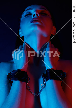 Girl with handcuffs on her hands Girl with handcuffs on her hands 70646406