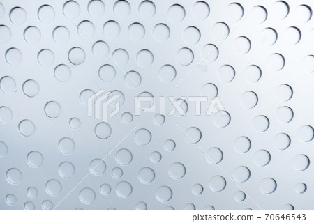 Matte metal surface with stamped round not through holes. 70646543