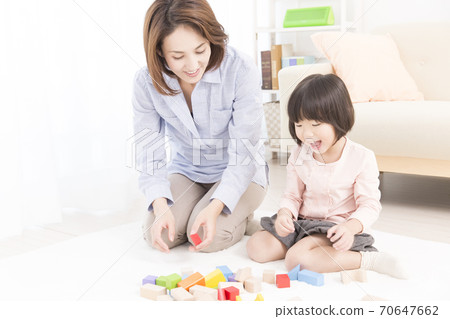 Mother and daughter playing with blocks 70647662