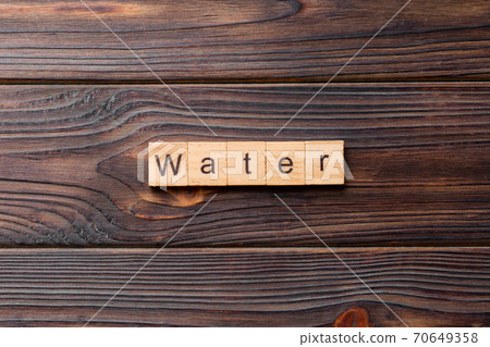 water word written on wood block. water text on cement table for your desing, concept 70649358