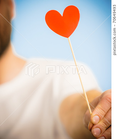 Man with heart on stick 70649493