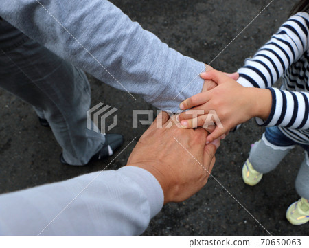 Three people put their hands together and fight Three people put their hands together and fight 70650063