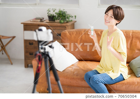 A woman who delivers recommended cosmetics videos in front of the camera A woman who delivers recommended cosmetics videos in front of the camera 70650304