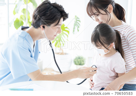 Girl undergoing medical examination 70650583