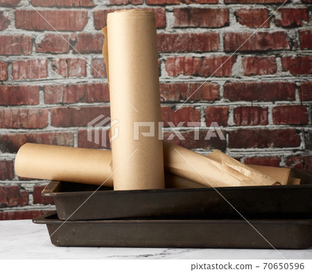 rolls of brown parchment paper on a white table rolls of brown parchment paper on a white table 70650596