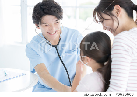 Girl undergoing medical examination 70650606