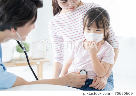 Girl undergoing medical examination 70650609